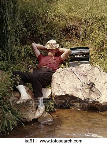 1960 1960S Retro Fishing Man Sleeping By Stream View Large Photo Image Stock Image - 1960 1960S Retro Fishing Man Sleeping By Stream. Fotosearch