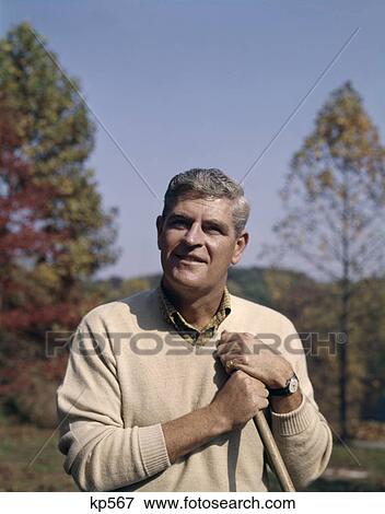 1960 1960S Retro Portrait Man Rakeing Yardwork Leaves View Large Photo Image Stock Photo - 1960 1960S Retro Portrait Man Rakeing Yardwork Leaves. Fotosearch
