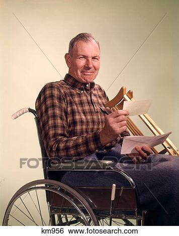 1960 1960S Senior Mature Man Smiling Holding Insurance Check Wheelchair Crutches View Large Photo Image Stock Photograph - 1960 1960S Senior Mature Man Smiling Holding Insurance Check Wheelchair Crutches . Fotosearch