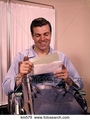 1960 1960S Smiling Man Holding Opening Insurance Check Letter Sitting In Wheelcahir Rehabilitation Patient View Large Photo Image Stock Photo - 1960 1960S Smiling Man Holding Opening Insurance Check Letter Sitting In Wheelcahir Rehabilitation Patient . Fotosearch