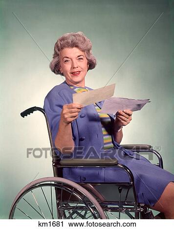 1960 1960S Smiling Senior Woman Opening Holding Insurance Check Letter Sitting Wheelchair View Large Photo Image Stock Image - 1960 1960S Smiling Senior Woman Opening Holding Insurance Check Letter Sitting Wheelchair . Fotosearch
