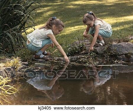 1960 1970 1960S 1970S Retro Girl Twins Water Creek Stream Reflection Playing Sandals View Large Photo Image Stock Photography - 1960 1970 1960S 1970S Retro Girl Twins Water Creek Stream Reflection Playing Sandals. Fotosearch