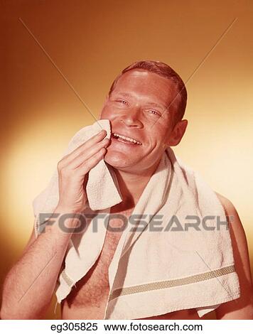 1960 Smiling Man Wiping Face With Beige Towel As If Looking In Bathroom Mirror After Shaving View Large Photo Image Stock Photography - 1960 Smiling Man Wiping Face With Beige Towel As If Looking In Bathroom Mirror After Shaving. Fotosearch