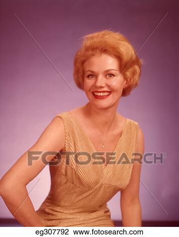 1960S 1960 Portrait Smiling Blonde Woman Wearing Gold V-Neck Dress View Large Photo Image Stock Image - 1960S 1960 Portrait Smiling Blonde Woman Wearing Gold V-Neck Dress. Fotosearch
