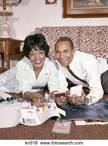 1960S 1970S Retro African-American Woman Man Couple Man Wife Together Planning Home Improvements Smiling View Large Photo Image Stock Photo - 1960S 1970S Retro African-American Woman Man Couple Man Wife Together Planning Home Improvements Smiling. Fotosearch