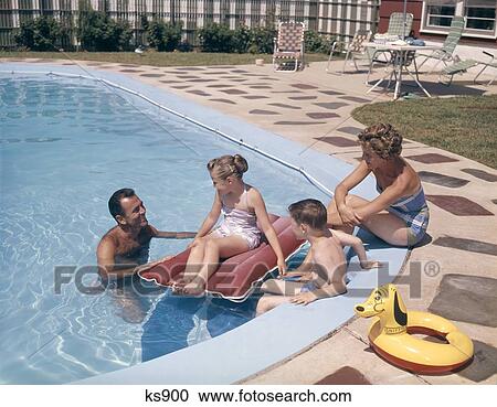 1960S 1970S Retro Family Father Mother Son Daughter Man Woman Boy Girl Together In Backyard Swimming Pool Smiling View Large Photo Image Stock Image - 1960S 1970S Retro Family Father Mother Son Daughter Man Woman Boy Girl Together In Backyard Swimming Pool Smiling. Fotosearch
