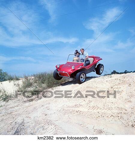 1960S 1970S Teenage Couple Man Woman Riding In Dune Buggy On Beach Sand View Large Photo Image Stock Image - 1960S 1970S Teenage Couple Man Woman Riding In Dune Buggy On Beach Sand . Fotosearch