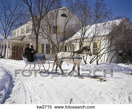 Stock Photography - 1960S 2 Men In One White Horse Drawn Open Sleigh By Country House Inn Snow Retro Vintage Winter Vermont. Fotosearch