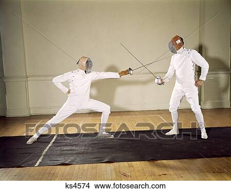 1960S 2 Men Wear White Padded Fencing Protective Gear Masks Helmet Sword Lunge Epee En Garde Touche View Large Photo Image Picture - 1960S 2 Men Wear White Padded Fencing Protective Gear Masks Helmet Sword Lunge Epee En Garde Touche. Fotosearch