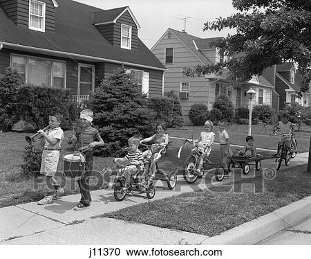 1960S 4Th Of July Bike Parade Of Boys & Girls Led By Bugler & Drummer With Bandaged Head All Decorated With American Flags View Large Photo Image Stock Image - 1960S 4Th Of July Bike Parade Of Boys & Girls Led By Bugler & Drummer With Bandaged Head All Decorated With American Flags . Fotosearch