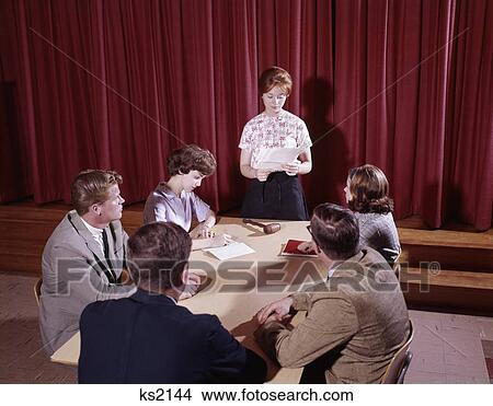 1960S 6 Teen Students Conference Table Red Velvet Curtain Behind Gavel Group Meeting Discussion Student Government View Large Photo Image Picture - 1960S 6 Teen Students Conference Table Red Velvet Curtain Behind Gavel Group Meeting Discussion Student Government. Fotosearch