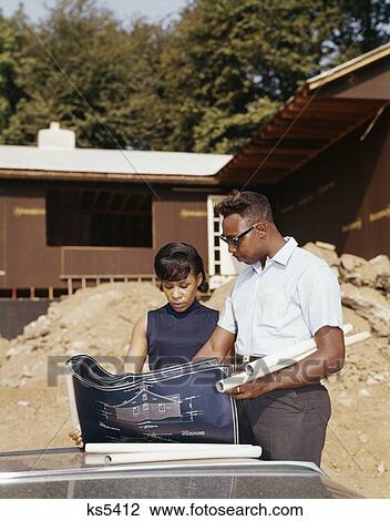1960S African-American Couple Looking At Blueprint Plans For New House Under Construction View Large Photo Image Stock Image - 1960S African-American Couple Looking At Blueprint Plans For New House Under Construction. Fotosearch