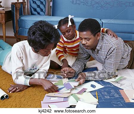 1960S African-American Family Of 3 Look At Paint Chips Blueprints Color Samples New Home Redecorate Mom Dad Girl View Large Photo Image Stock Image - 1960S African-American Family Of 3 Look At Paint Chips Blueprints Color Samples New Home Redecorate Mom Dad Girl. Fotosearch
