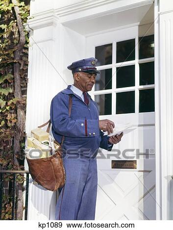 1960S African-American Man Mailman Retro Carrying Mailbag Sorting Letters Front Door Delivery Delivering Usps View Large Photo Image Stock Photo - 1960S African-American Man Mailman Retro Carrying Mailbag Sorting Letters Front Door Delivery Delivering Usps . Fotosearch