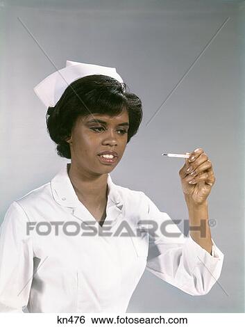1960S African-American Woman Nurse Uniform Reading Thermometer View Large Photo Image Stock Photograph - 1960S African-American Woman Nurse Uniform Reading Thermometer . Fotosearch