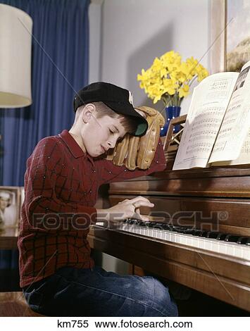 1960S Annoyed Looking Boy With Baseball Cap And Glove Practicing Piano Lesson Mitt Impatient Responsibility Priority View Large Photo Image Stock Photography - 1960S Annoyed Looking Boy With Baseball Cap And Glove Practicing Piano Lesson Mitt Impatient Responsibility Priority. Fotosearch