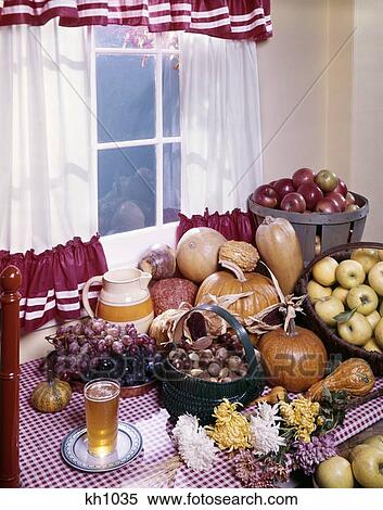 1960S Autumn Harvest Vegetables Pumpkin Apple Squash Nuts Grapes Cider Red White Kitchen Table Window Curtains View Large Photo Image Stock Photography - 1960S Autumn Harvest Vegetables Pumpkin Apple Squash Nuts Grapes Cider Red White Kitchen Table Window Curtains . Fotosearch