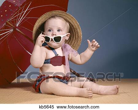 1960S Baby Girl Bathing Suit Straw Hat Sunglasses Umbrella View Large Photo Image Stock Photography - 1960S Baby Girl Bathing Suit Straw Hat Sunglasses Umbrella. Fotosearch