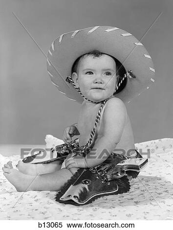 1960S Baby Girl Wearing Cowboy Hat Toy Holster And Guns Indoor View Large Photo Image Stock Photography - 1960S Baby Girl Wearing Cowboy Hat Toy Holster And Guns Indoor . Fotosearch