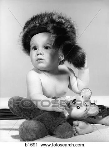 Stock Image - 1960S Baby Wearing Coonskin Hat . Fotosearch
