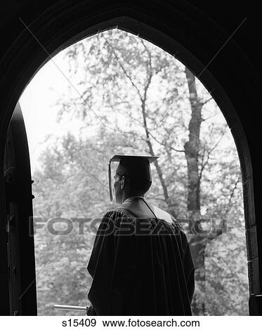 1960S Back View Of Graduate Standing In Dark Arched Doorway With Trees In Sunlit Background View Large Photo Image Stock Photo - 1960S Back View Of Graduate Standing In Dark Arched Doorway With Trees In Sunlit Background . Fotosearch