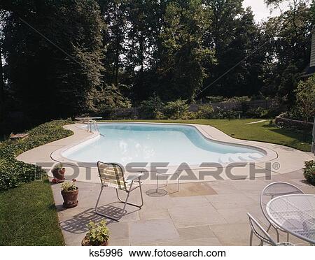 1960'S Backyard Swimming Pool Area With Patio Outdoor Kidney Shape 1970'S View Large Photo Image Stock Photograph - 1960'S Backyard Swimming Pool Area With Patio Outdoor Kidney Shape 1970'S. Fotosearch