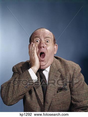 Stock Image - 1960S Balding Businessman Holding Hand Up To Face Shocked Expression Eyes Bulging Mouth Open. Fotosearch