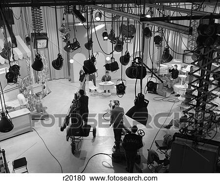 1960S Behind-The-Scenes Filming Of Tv Talk Show In Studio With Several Light Fixtures And Monitors Hanging From Ceiling View Large Photo Image Stock Image - 1960S Behind-The-Scenes Filming Of Tv Talk Show In Studio With Several Light Fixtures And Monitors Hanging From Ceiling. Fotosearch