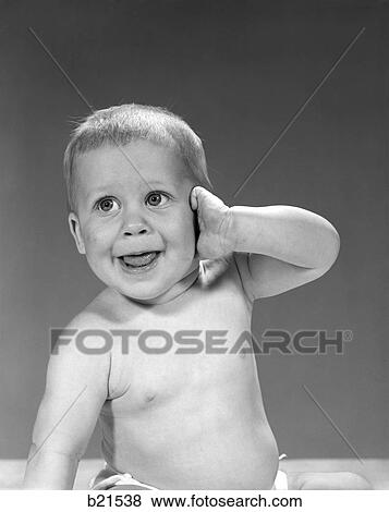 1960S Big Eyed Baby With Mouth Open And Tongue Showing Holding 1 Arm Up With His Hand Against His Ear View Large Photo Image Stock Photo - 1960S Big Eyed Baby With Mouth Open And Tongue Showing Holding 1 Arm Up With His Hand Against His Ear . Fotosearch
