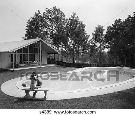 1960S Blonde In Bathing Suit Sitting On Stone Bench At End Of Kidney-Shaped Pool View Large Photo Image Stock Photo - 1960S Blonde In Bathing Suit Sitting On Stone Bench At End Of Kidney-Shaped Pool. Fotosearch