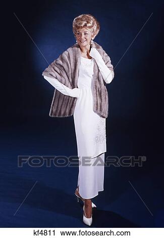 1960S Blonde Middle Aged Woman Long White Gown Gloves Wearing Fur Stole Formal Attire Elegant Full Length View Large Photo Image Stock Image - 1960S Blonde Middle Aged Woman Long White Gown Gloves Wearing Fur Stole Formal Attire Elegant Full Length . Fotosearch