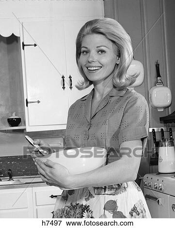 1960S Blonde Woman Housewife In Kitchen Holding Mixing Bowl & Spoon Smiling View Large Photo Image Stock Photo - 1960S Blonde Woman Housewife In Kitchen Holding Mixing Bowl & Spoon Smiling . Fotosearch