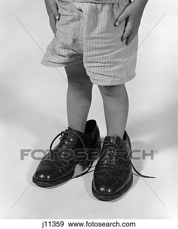 1960S Boy Waist Down Wearing Father'S Shoes View Large Photo Image Stock Photo - 1960S Boy Waist Down Wearing Father'S Shoes . Fotosearch
