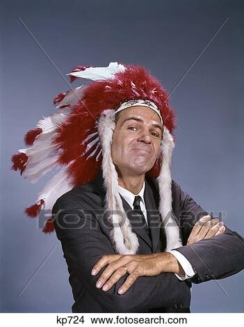 1960S Character Wear Native American Indian Feather Headdress Chief Leader Facial Expression Arms Folded Gesture View Large Photo Image Picture - 1960S Character Wear Native American Indian Feather Headdress Chief Leader Facial Expression Arms Folded Gesture . Fotosearch