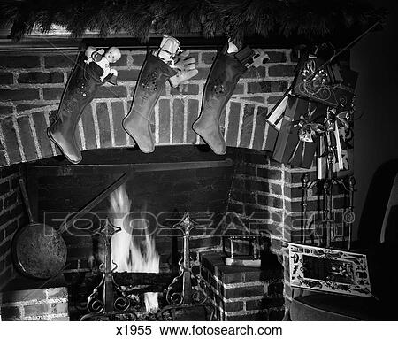 1960S Christmas Stockings Full Of Toys Hanging Over Fireplace View Large Photo Image Stock Photography - 1960S Christmas Stockings Full Of Toys Hanging Over Fireplace . Fotosearch