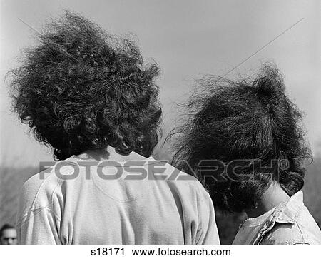 1960S Close-Up Back View Of Hippie Boy & Girl Couple Man & Woman With Long Wild Hair Blowing Free In The Wind View Large Photo Image Stock Image - 1960S Close-Up Back View Of Hippie Boy & Girl Couple Man & Woman With Long Wild Hair Blowing Free In The Wind . Fotosearch