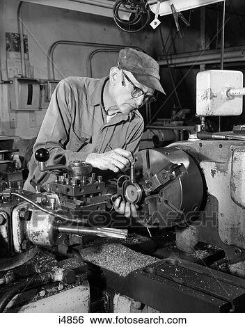 1960S Close-Up Of Elderly Man In Cap & Glasses With Pencil Behind Ear Working On Lathe In Industrial Factory Setting View Large Photo Image Stock Photograph - 1960S Close-Up Of Elderly Man In Cap & Glasses With Pencil Behind Ear Working On Lathe In Industrial Factory Setting . Fotosearch