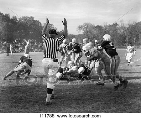 1960S Close-Up Of Football Game With Ball Carrier Being Tackled & Referee Whistling The Play Dead View Large Photo Image Stock Photo - 1960S Close-Up Of Football Game With Ball Carrier Being Tackled & Referee Whistling The Play Dead . Fotosearch
