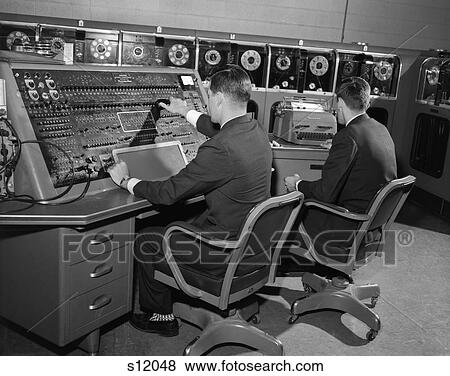 1960S Computer Room With 2 Men Working At Console And Typewriter View Large Photo Image Stock Photo - 1960S Computer Room With 2 Men Working At Console And Typewriter . Fotosearch