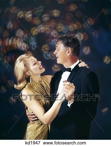 Stock Photo - 1960S Couple In Formal Clothes Dancing Multiple Light Background Celebration Anniversary Man Woman. Fotosearch