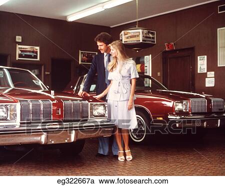 1960S Couple Looking At Car In Show Room View Large Photo Image Stock Image - 1960S Couple Looking At Car In Show Room. Fotosearch