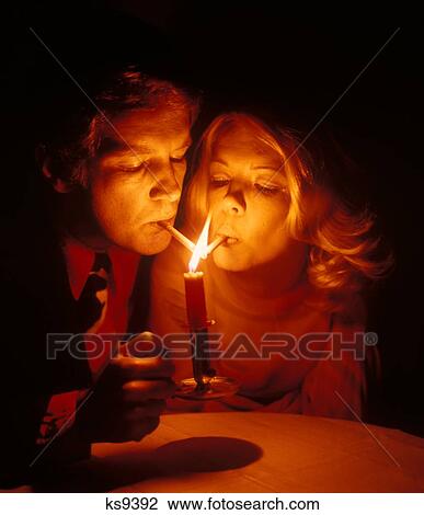 1960S Couple Man Woman Romantic Lighting Candlelight Lighting Cigarettes Flame Smoke Smoking Cigarette Tobacco Hazard View Large Photo Image Stock Image - 1960S Couple Man Woman Romantic Lighting Candlelight Lighting Cigarettes Flame Smoke Smoking Cigarette Tobacco Hazard. Fotosearch