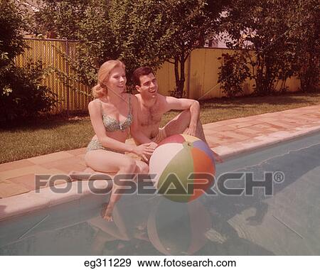1960S Couple Sitting On Edge Of Swimming Pool View Large Photo Image Stock Photo - 1960S Couple Sitting On Edge Of Swimming Pool. Fotosearch