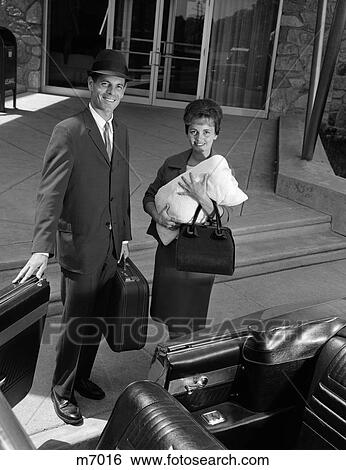 1960S Couple Taking New Baby Wrapped In Blanket Home From Hospital Man Holds Car Door Open For Woman View Large Photo Image Stock Photograph - 1960S Couple Taking New Baby Wrapped In Blanket Home From Hospital Man Holds Car Door Open For Woman . Fotosearch