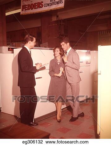 1960S Couple Talking To Salesman Buying Refrigerator View Large Photo Image Stock Image - 1960S Couple Talking To Salesman Buying Refrigerator. Fotosearch