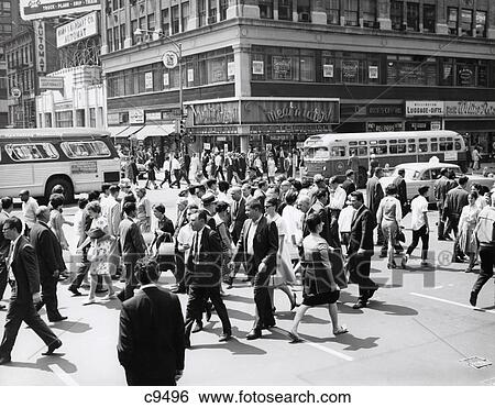 1960S Crowd Crossing Busy Intersection In New York City With Bus & Cab In Background View Large Photo Image Stock Photograph - 1960S Crowd Crossing Busy Intersection In New York City With Bus & Cab In Background . Fotosearch
