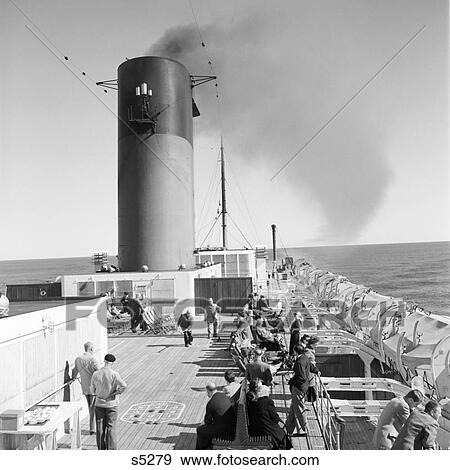 1960S Crowd On Deck Of Ss Isle De France Some Looking At The Ocean From Deck Chairs Or Railing Some Playing Shuffleboard View Large Photo Image Stock Photo - 1960S Crowd On Deck Of Ss Isle De France Some Looking At The Ocean From Deck Chairs Or Railing Some Playing Shuffleboard. Fotosearch