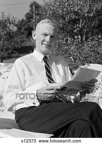 1960S Elderly Man In Shirt & Tie Sitting On Lawn Furniture Reading Pamphlet View Large Photo Image Stock Image - 1960S Elderly Man In Shirt & Tie Sitting On Lawn Furniture Reading Pamphlet . Fotosearch