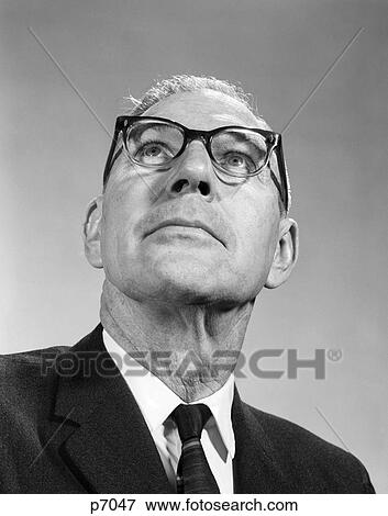 1960S Elderly Man Wearing Eye Glasses Looking Up At Odd Angle Chin Neck Suit Tie Optical Vision View Large Photo Image Stock Photo - 1960S Elderly Man Wearing Eye Glasses Looking Up At Odd Angle Chin Neck Suit Tie Optical Vision . Fotosearch