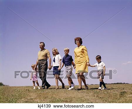 1960S Family Father Mother Daughter 3 Sons Walking Together Forward Hand Holding Nostalgia Retro Vintage Unity View Large Photo Image Stock Photo - 1960S Family Father Mother Daughter 3 Sons Walking Together Forward Hand Holding Nostalgia Retro Vintage Unity. Fotosearch